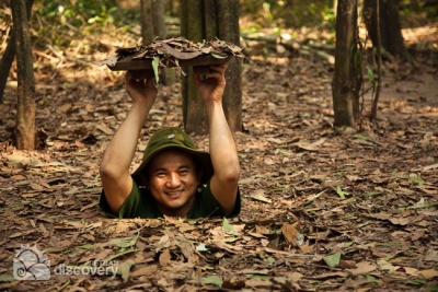 Trying to fit the exit at Cu Chi Tunnels - Day Trip from Ho Chi Minh City