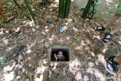 Trying to fit exit and entrance Cu Chi - HCM City tour by Julia Sumangil